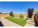 Backyard featuring artificial turf and brick-paved patio at 6730 Pivot Point St, Las Vegas, NV 89148