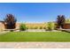 Backyard featuring artificial turf and brick-paved patio at 6730 Pivot Point St, Las Vegas, NV 89148