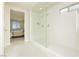 Modern bathroom featuring a glass-enclosed shower and neutral tiling at 6730 Pivot Point St, Las Vegas, NV 89148