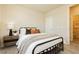Comfortable bedroom featuring neutral walls, wood-look tile flooring and a nightstand at 6730 Pivot Point St, Las Vegas, NV 89148