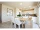 Bright dining room area features an open concept kitchen and an adjacent staircase at 6730 Pivot Point St, Las Vegas, NV 89148