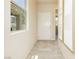Inviting entryway featuring tile floors, white walls and a window with natural light at 6730 Pivot Point St, Las Vegas, NV 89148