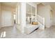 Bright entryway with tile flooring, a bench, decorative mirror and staircase at 6730 Pivot Point St, Las Vegas, NV 89148