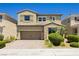 Charming two-story house showcasing a stone facade, two-car garage and well-maintained landscaping at 6730 Pivot Point St, Las Vegas, NV 89148