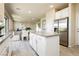 Open concept kitchen with an island flowing into the dining and living area at 6730 Pivot Point St, Las Vegas, NV 89148