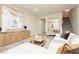 Bright living room featuring wood-look tile floors, a white sofa and a staircase at 6730 Pivot Point St, Las Vegas, NV 89148