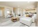 Spacious living room featuring a white sofa, staircase, and an open floor plan at 6730 Pivot Point St, Las Vegas, NV 89148