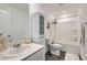 Bright bathroom featuring shower/tub combination, vanity, storage and dark tile flooring at 6938 Feather Hill St, North Las Vegas, NV 89086