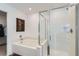Bright bathroom with a large soaking tub and glass shower with modern fixtures at 6938 Feather Hill St, North Las Vegas, NV 89086