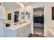 Bright bathroom with a double sink vanity, large mirror and walk in closet entrance at 6938 Feather Hill St, North Las Vegas, NV 89086