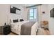A calming bedroom featuring light hardwood floors, a window, and modern decor at 6938 Feather Hill St, North Las Vegas, NV 89086