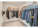 Walk in closet with ample built-in storage, hanging rods, baskets and carpet flooring at 6938 Feather Hill St, North Las Vegas, NV 89086