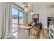 Elegant dining area filled with natural light, featuring a modern pendant lighting and an easy access to the outdoor space at 6938 Feather Hill St, North Las Vegas, NV 89086