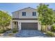 Charming two-story home featuring a paved driveway and inviting curb appeal with mature trees and lovely landscaping at 6938 Feather Hill St, North Las Vegas, NV 89086