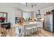 Modern kitchen featuring stainless steel appliances, a center island with seating, and ample cabinet space, perfect for cooking at 6938 Feather Hill St, North Las Vegas, NV 89086