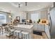 Well-lit kitchen with stylish countertops, stainless steel appliances, and a functional island with seating, creating a modern appeal at 6938 Feather Hill St, North Las Vegas, NV 89086