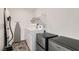 Functional laundry room with modern appliances, storage shelving, and ample space for completing laundry tasks at 6938 Feather Hill St, North Las Vegas, NV 89086