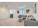 Spacious living room with a gray sofa, entertainment area, and neutral-toned carpet for a cozy atmosphere at 6938 Feather Hill St, North Las Vegas, NV 89086