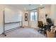 Office with a large whiteboard, grey carpet, and bright natural light at 6938 Feather Hill St, North Las Vegas, NV 89086