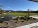 Community park featuring a green lawn, grill, and walking paths with desert landscaping at 6938 Feather Hill St, North Las Vegas, NV 89086