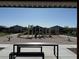 A playground with climbing structures and slides can be seen from under a picnic table at 6938 Feather Hill St, North Las Vegas, NV 89086