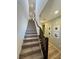 A carpeted stairway with a dark wood railing leads to the upper level of the home at 6938 Feather Hill St, North Las Vegas, NV 89086