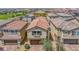 Aerial view of a cozy single-Gathering home with a brick driveway and a red tile roof at 7011 Toll Mountain St, North Las Vegas, NV 89086