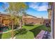 Backyard oasis featuring artificial turf, hammock, trampoline, and lounge area, perfect for outdoor entertaining at 7011 Toll Mountain St, North Las Vegas, NV 89086