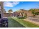 Spacious backyard with artificial turf, trampoline, grill, and lounge seating area at 7011 Toll Mountain St, North Las Vegas, NV 89086