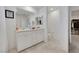 Bathroom with modern vanity, sink, and mirror, adjacent to toilet and walk-in closet at 7011 Toll Mountain St, North Las Vegas, NV 89086