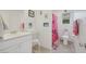 Bright ' bathroom featuring a vanity, toilet, and shower with curtain at 7011 Toll Mountain St, North Las Vegas, NV 89086
