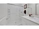 Clean bathroom with glass-enclosed shower, white vanity, and modern fixtures at 7011 Toll Mountain St, North Las Vegas, NV 89086