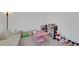 A bright and cheerful bedroom space perfect for children, complete with cozy seating and ample storage at 7011 Toll Mountain St, North Las Vegas, NV 89086