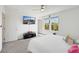 Cozy bedroom featuring a plush bed, wall-mounted TV, and windows providing natural light and scenic views at 7011 Toll Mountain St, North Las Vegas, NV 89086