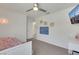 Bright bedroom featuring a ceiling fan, white walls, and TV at 7011 Toll Mountain St, North Las Vegas, NV 89086