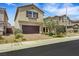 Charming two story home with desert landscaping, brick driveway, and an attached garage at 7011 Toll Mountain St, North Las Vegas, NV 89086