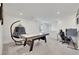 Bright game room with air hockey table, desk, and comfy chair at 7011 Toll Mountain St, North Las Vegas, NV 89086