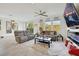 Open-concept living room with tile floors, neutral paint, and sliding glass door at 7011 Toll Mountain St, North Las Vegas, NV 89086