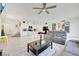 Expansive open-concept living room with island seating and modern lighting fixtures at 7011 Toll Mountain St, North Las Vegas, NV 89086