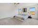 Spacious main bedroom featuring plush carpeting, modern furnishings, and large windows for ample natural light at 7011 Toll Mountain St, North Las Vegas, NV 89086