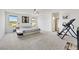 Spacious main bedroom featuring plush carpeting, modern furnishings, and large windows for ample natural light at 7011 Toll Mountain St, North Las Vegas, NV 89086
