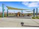 Community playground featuring slides, climbing structures, and shaded seating areas at 7011 Toll Mountain St, North Las Vegas, NV 89086