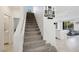 Carpeted staircase leading to the second floor with bright natural light at 7011 Toll Mountain St, North Las Vegas, NV 89086