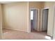 Bedroom with neutral walls, beige carpet, and white trim; door open to another room at 7563 Captain Lord Ct, Las Vegas, NV 89166
