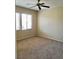 Neutral bedroom features beige carpet, a ceiling fan, windows with blinds, and neutral walls at 7563 Captain Lord Ct, Las Vegas, NV 89166