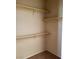 Walk-in closet features white shelving with wooden rods, neutral paint and neutral carpeting at 7563 Captain Lord Ct, Las Vegas, NV 89166