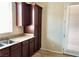 Kitchen with dark cabinets, a stainless steel sink, and access to the backyard at 7563 Captain Lord Ct, Las Vegas, NV 89166