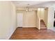 Open living room with stairs, wood floors, and a light fixture at 7563 Captain Lord Ct, Las Vegas, NV 89166