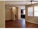 Open living room with stairs, wood floors, and two windows at 7563 Captain Lord Ct, Las Vegas, NV 89166