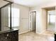 Bathroom showing a shower, connecting room, and tile flooring at 7861 Hamilton Pool Dr, Las Vegas, NV 89113